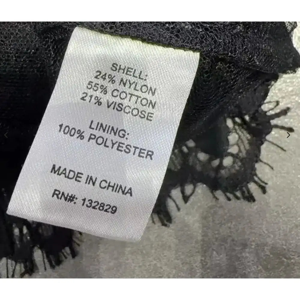 Clothing label with material composition details on a textured background