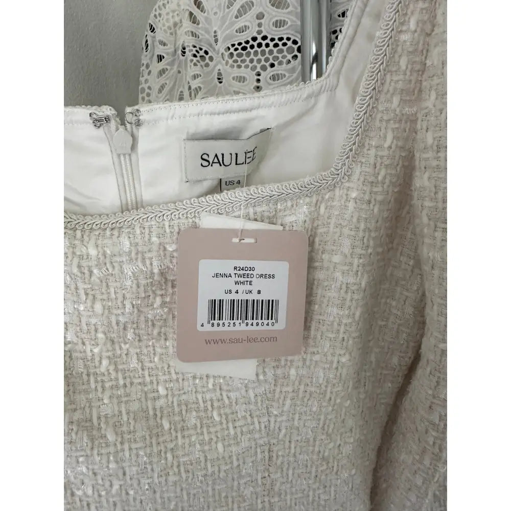 Close-up of a dress with a SAULE label and tag.